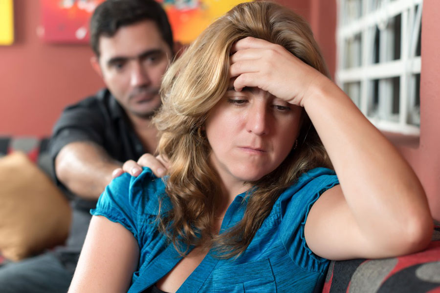 Divorce, marital problems - Sad wife with her husband in the bac